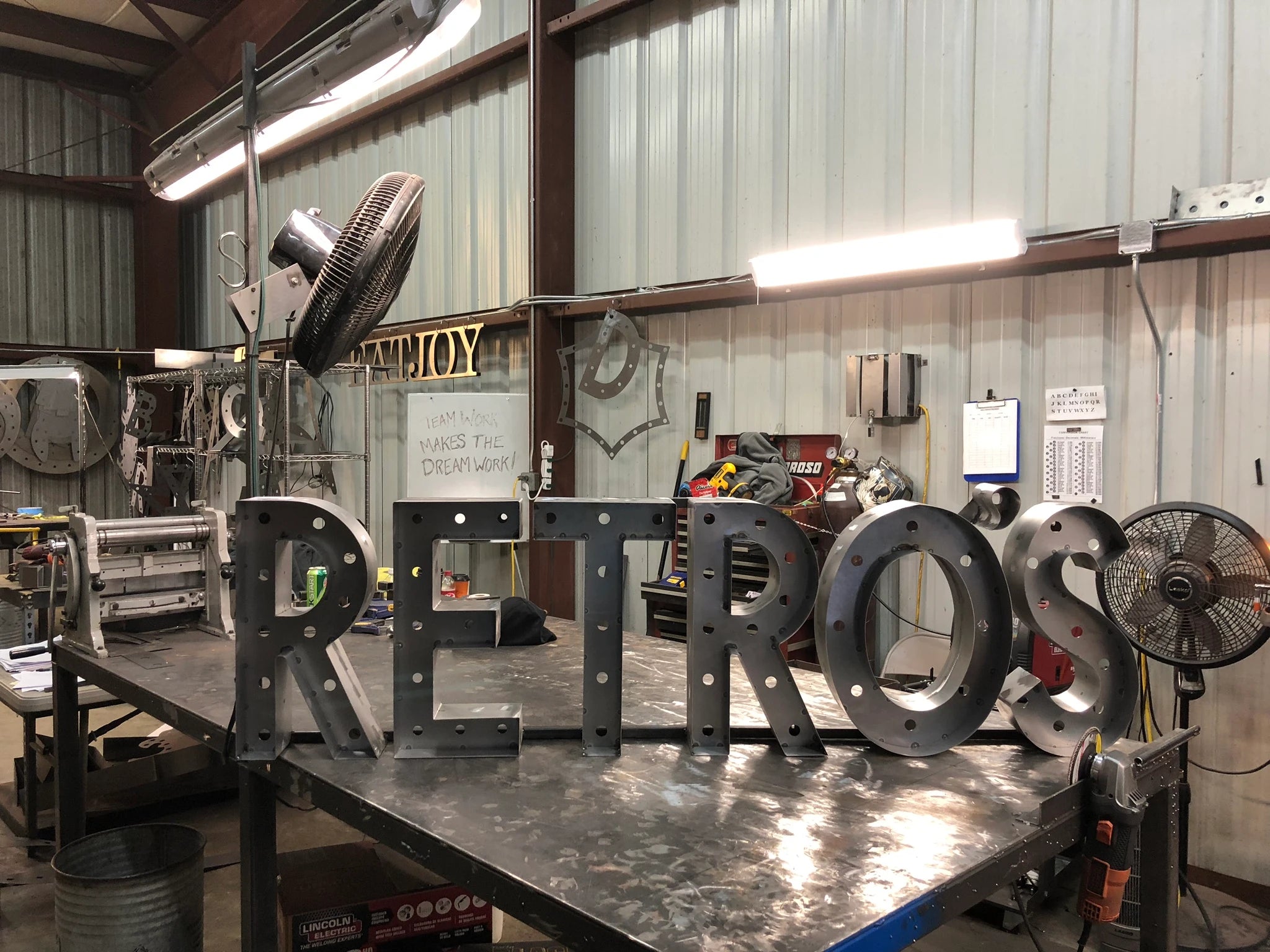 Lit marquee pieces on the shop bench
